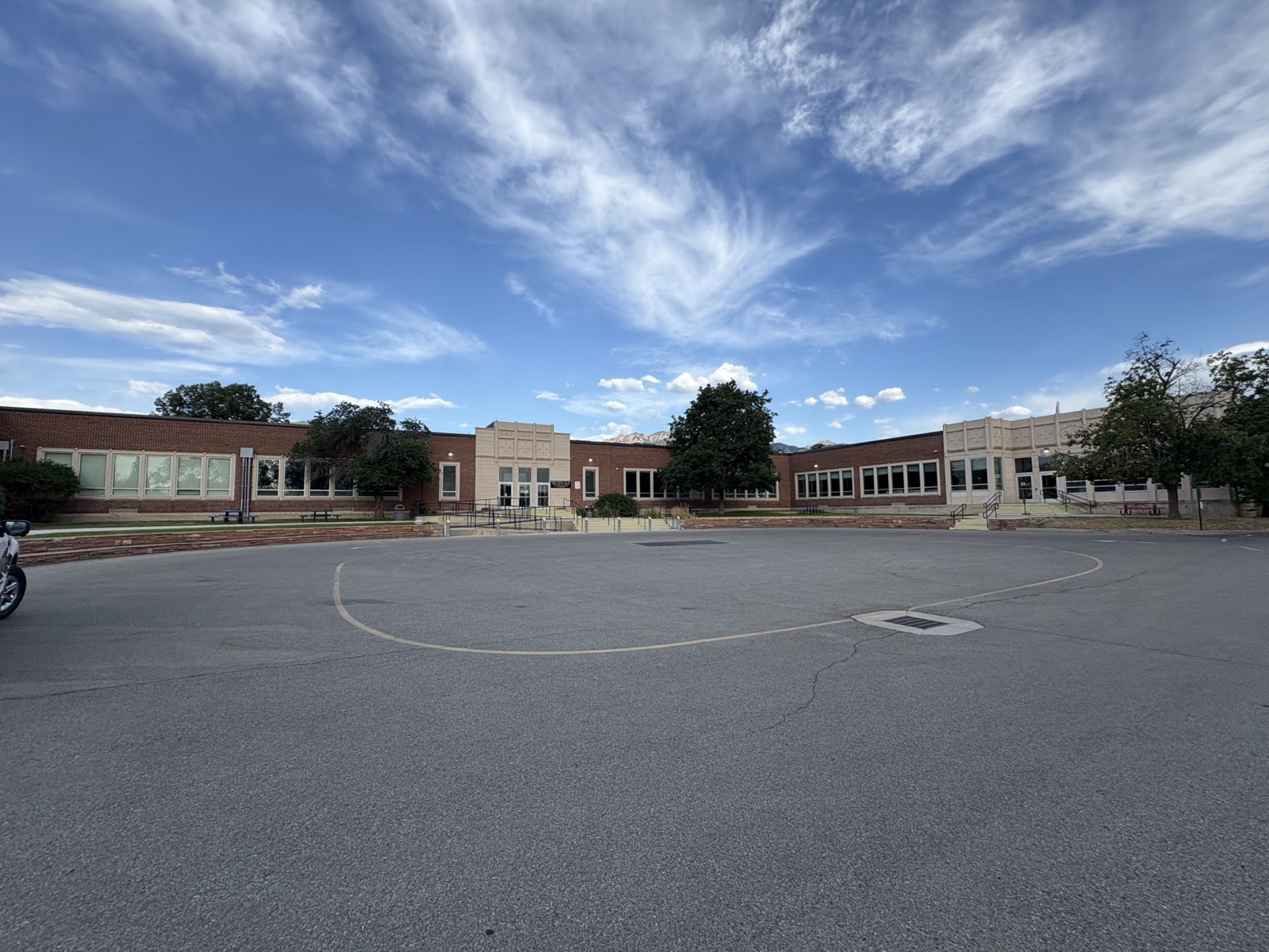 The main school building at the USDB Salt Lake / Millcreek campus, brick with a large paved play loop in front